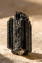 Sensorium Black Tourmaline — Boundary, natural black tourmaline specimen on warm travertine