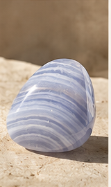 Sensorium Blue Lace Agate — Ease, polished blue lace agate on warm travertine